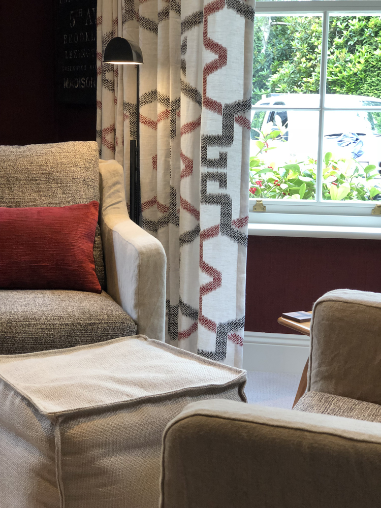 Pair of bespoke swivel chairs with floor lamp and wave curtain